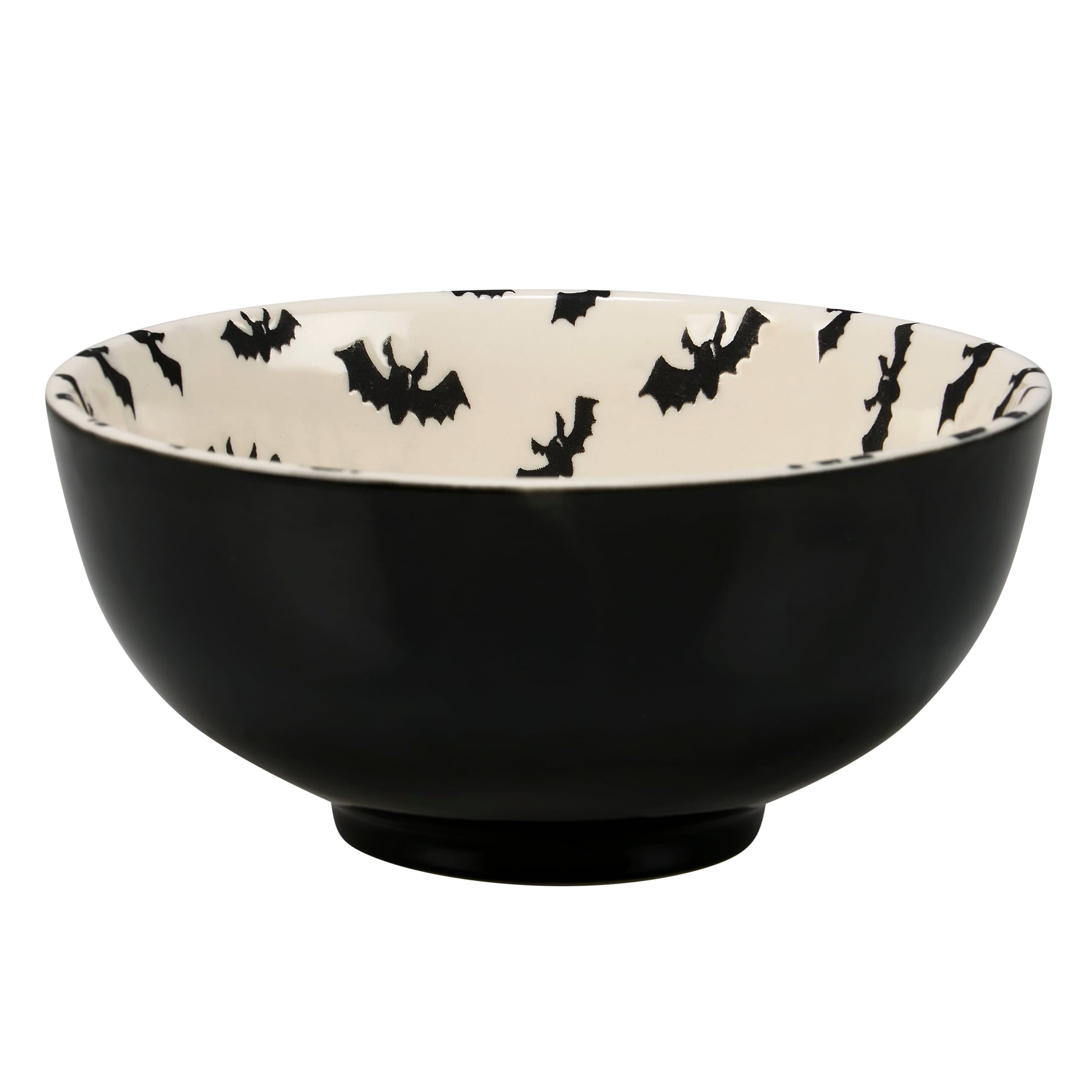 Black ceramic jack o’lantern bowl with white interior and black bat silhouettes part of a spooky bowl set