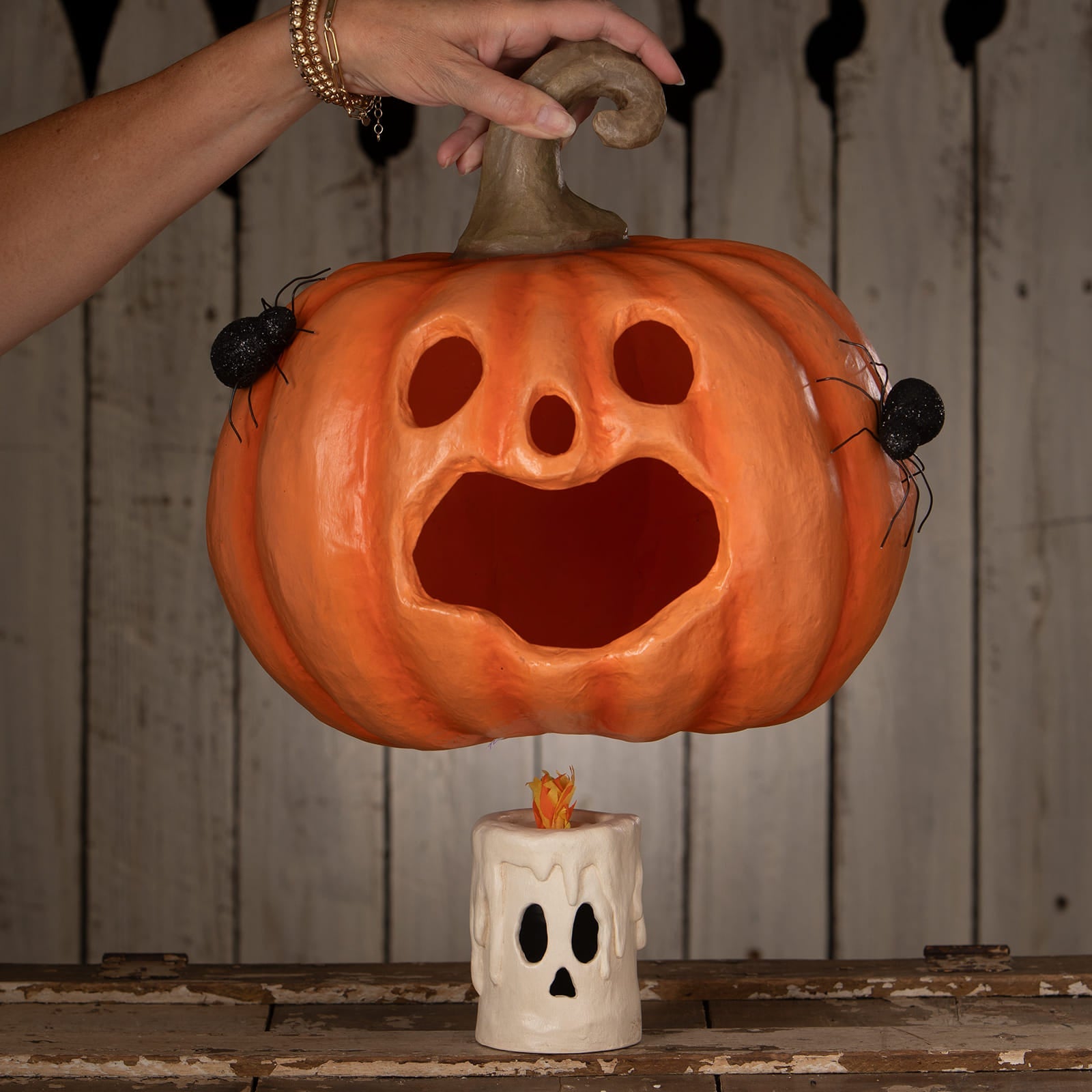 Orange halloween pumpkin jack o lantern with spooky carved face and two black spiders from jackie boo lantern