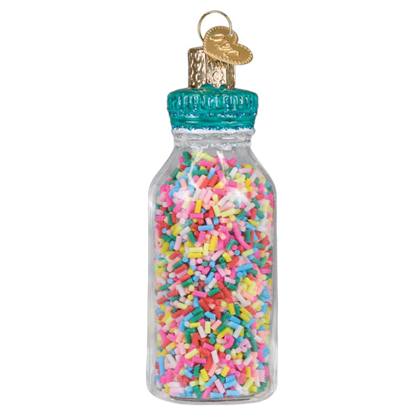 A clear glass jar of sprinkles ornament with a teal cap and gold heart tag figural decor for tree toppers or pickles ornament