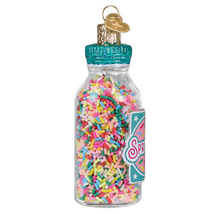 A clear glass jar of sprinkles ornament with colorful rainbow sprinkles teal cap and gold heart keychain figural decor