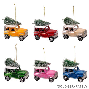 Six colorful glitter jeep hauling christmas tree ornaments with frosted mini trees on their roofs for holiday decor