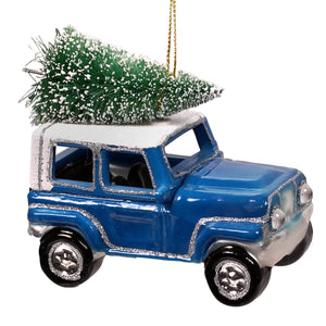 Blue vintage-style jeep hauling christmas tree ornament with silver glitter trim and frosted green tree on roof