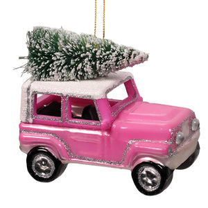 Pink glittery glass jeep hauling christmas tree ornament with frosted pine tree on roof perfect for holiday decor