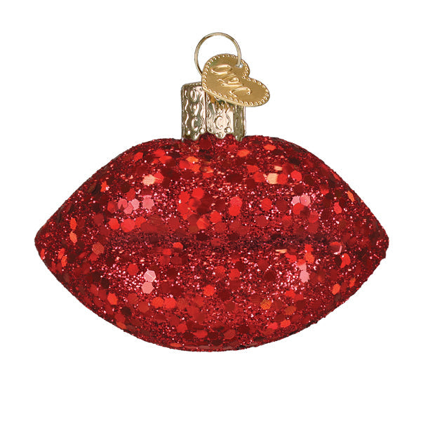 A sparkling red glitter lipstick ornament with gold heart tag and metallic cap glass and glitter figural decor