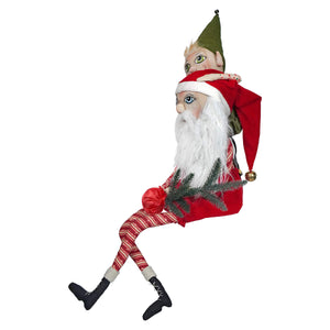 A whimsical elf perched atop a painted fabric santa figure with detailed stitching in folk art santas christmas decorations