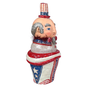 A whimsical hand-painted johanna parker uncle sam container with silver glitter hair and a patriotic stars and stripes outfit