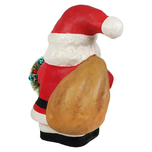 Jolly fat santa by bethany lowe designs with glittery beard carrying tan sack and green wreath with ornaments