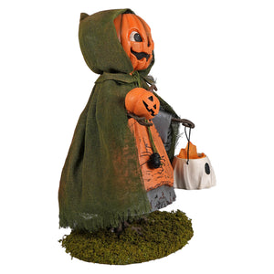 Jolly jack pumpkin halloween figural decor featuring a pumpkin-headed child in an olive green burlap cloak holding a pumpkin and ghost bucket