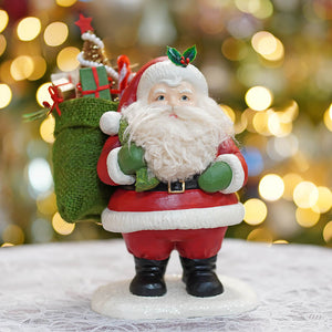 Red and white jolly retro santa figurine with green sack black boots and holly sprig on hat by bethany lowe