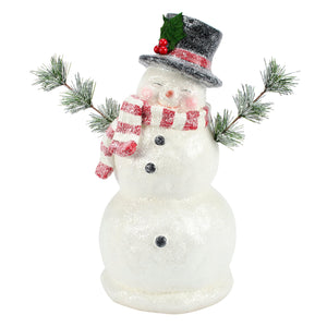 A festive white glittery jolly snowman figurine with a black top hat scarf holding pine branches christmas snowman figures decor
