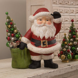 Jolly waving santa figurine by bethany lowe designs in red and white glitter holding a green sack with ornaments and mouse