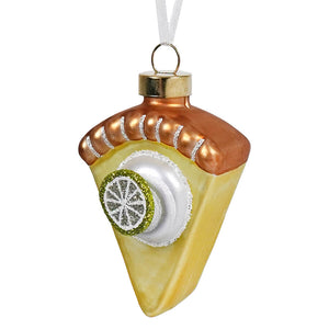 Key lime pie ornament with translucent glass, golden-brown crust, yellow filling, and glittery green lime slice decoration food and drink ornaments