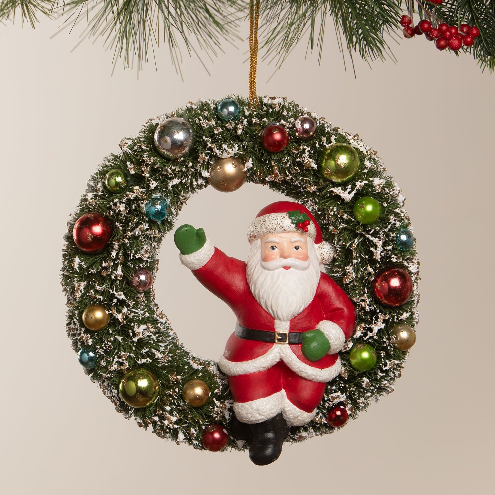 A kitschmas santa christmas wreath ornament by bethany lowe design with santa in red suit on frosted green garland