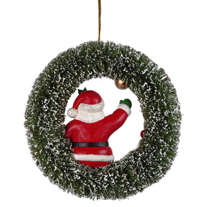 Red and white kitschmas santa figurine peeking through a frosted green christmas wreath by bethany lowe design