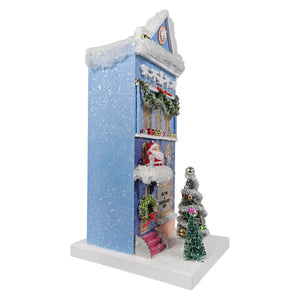 Blue cody foster knitting & haberdashery shop christmas house ornament with snow-dusted roof and santa figure at entrance