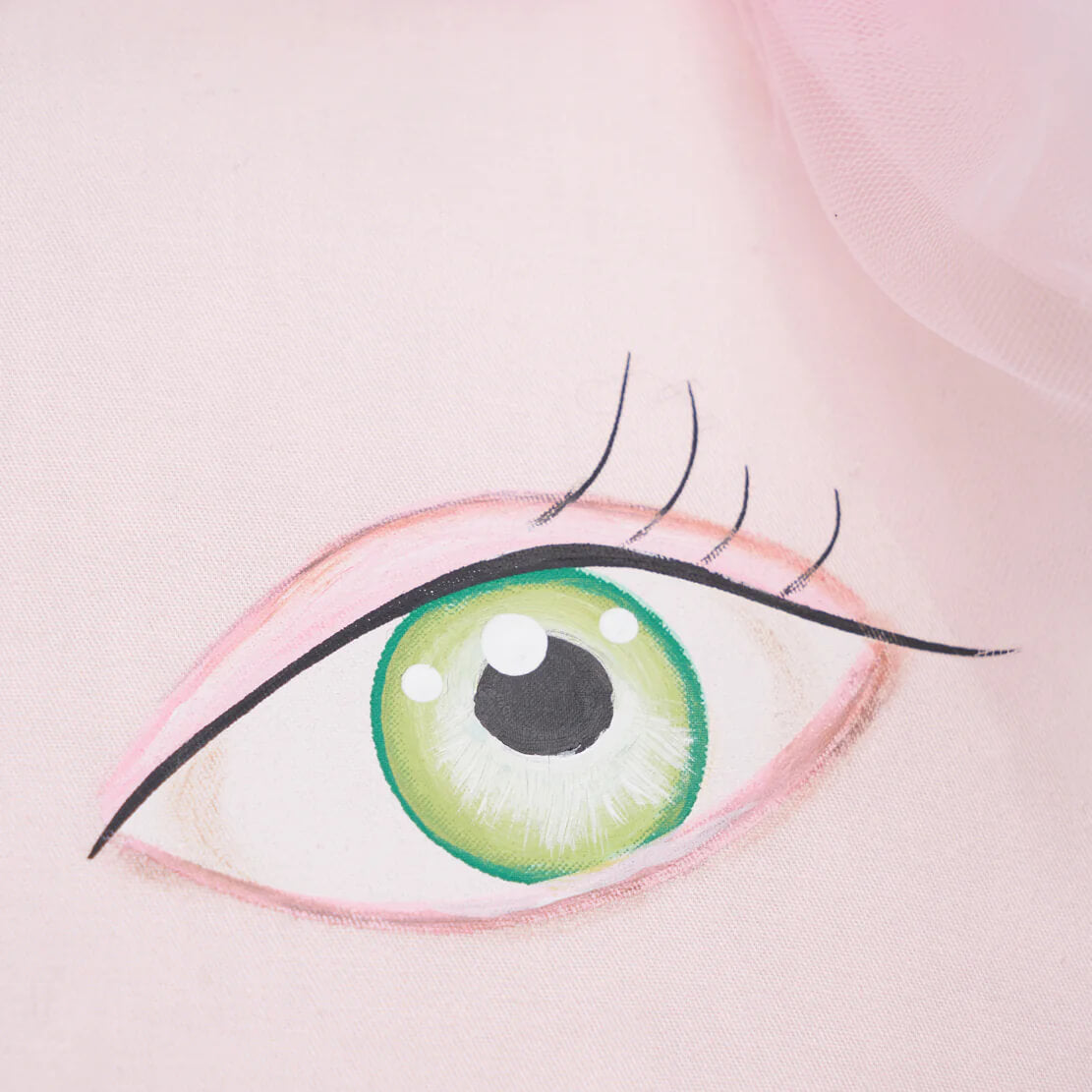 Koko zombinaland decorative pillow with a stylized green eye design painted on soft pink fabric by tracy scheff pillow
