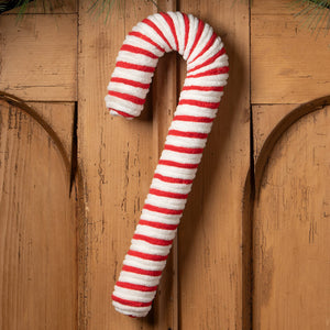 Large chenille candy cane wreath by bethany lowe with plush red and white stripes hanging on wooden door