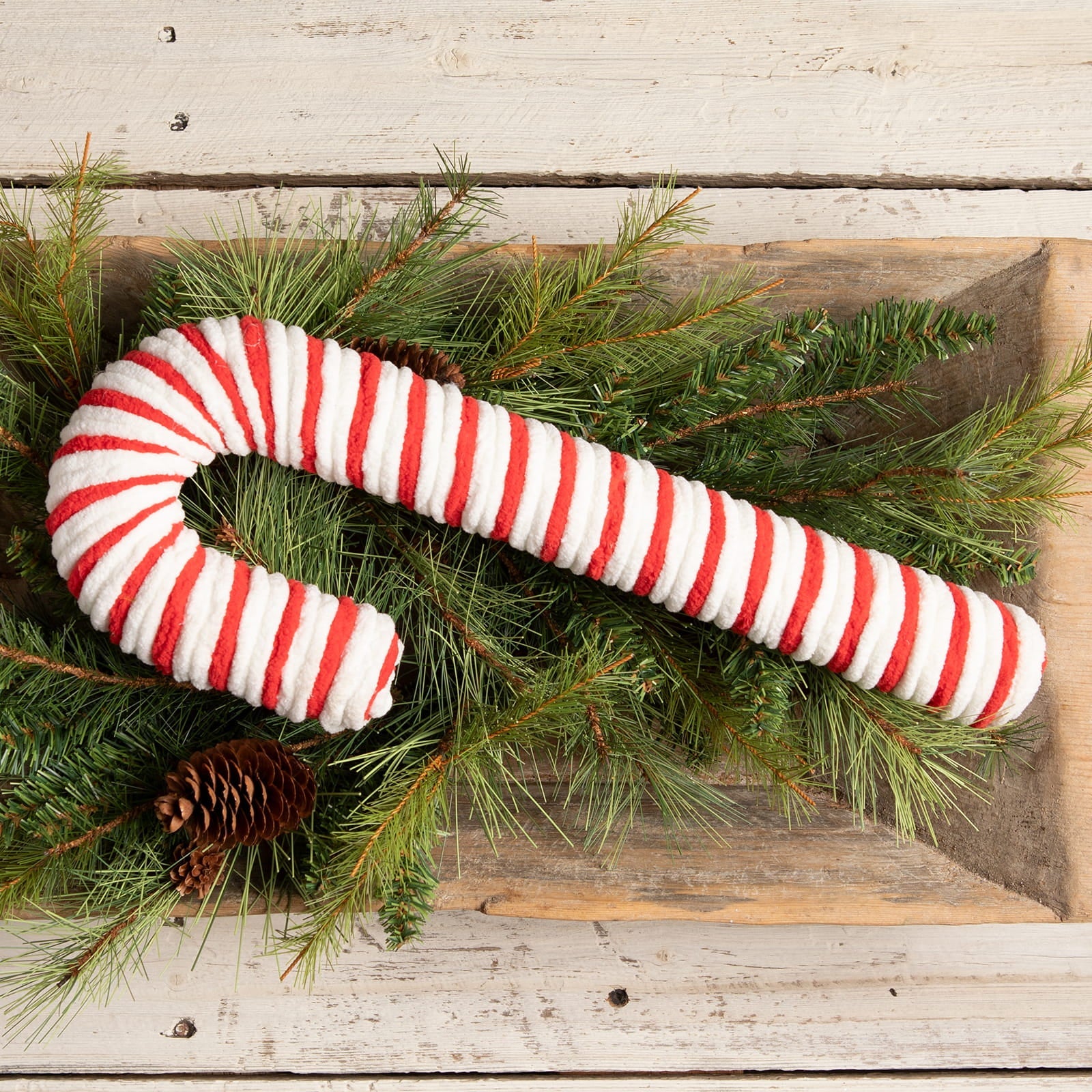 A large chenille candy cane by Bethany Lowe with plush red and white stripes and a soft textured surface