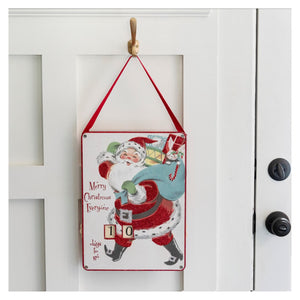 Large christmas countdown wheel featuring a red and white vintage santa claus design with red ribbon straps by annie schickel design