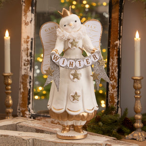 White angel figure with gold crown holding glittery winter banner with stars perfect for snow angel decor