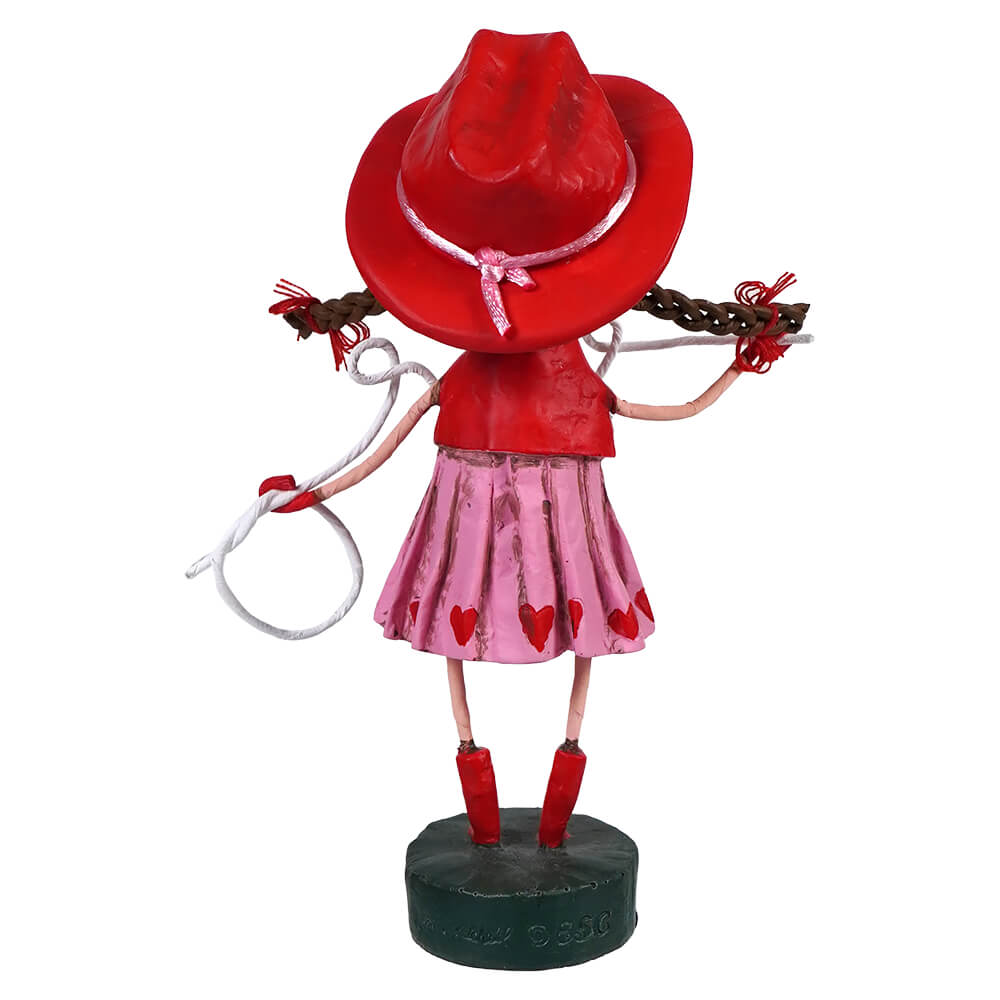 Decorative cowgirl figurine wearing a red hat, pink skirt, and red boots with braided pigtails.