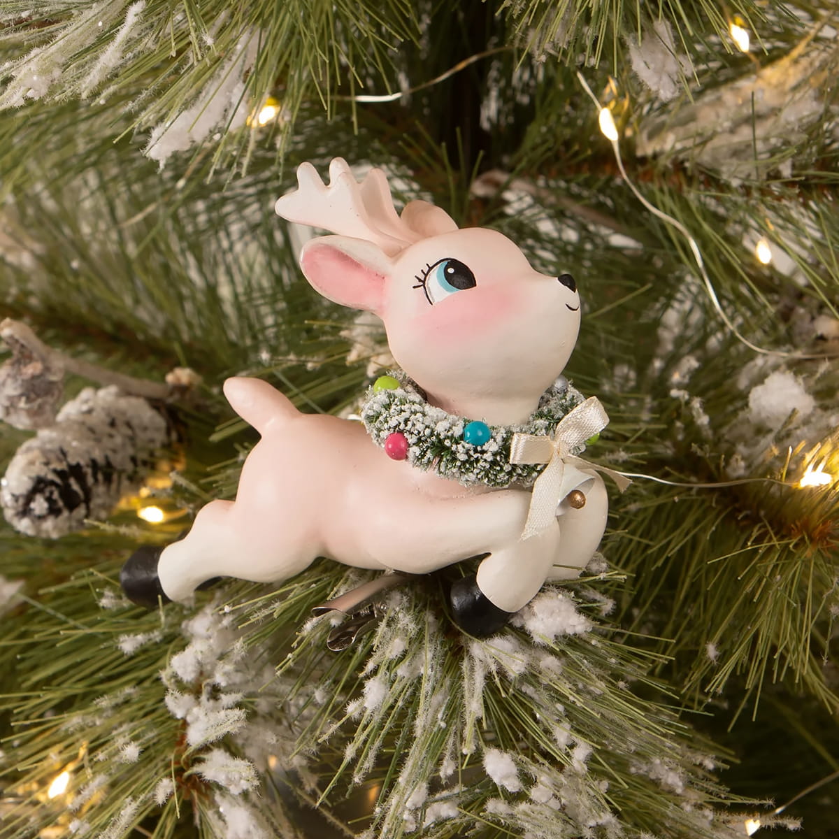 A charming pink ceramic leaping high reindeer clip-on ornament with green garland and colorful beads by bethany lowe designs