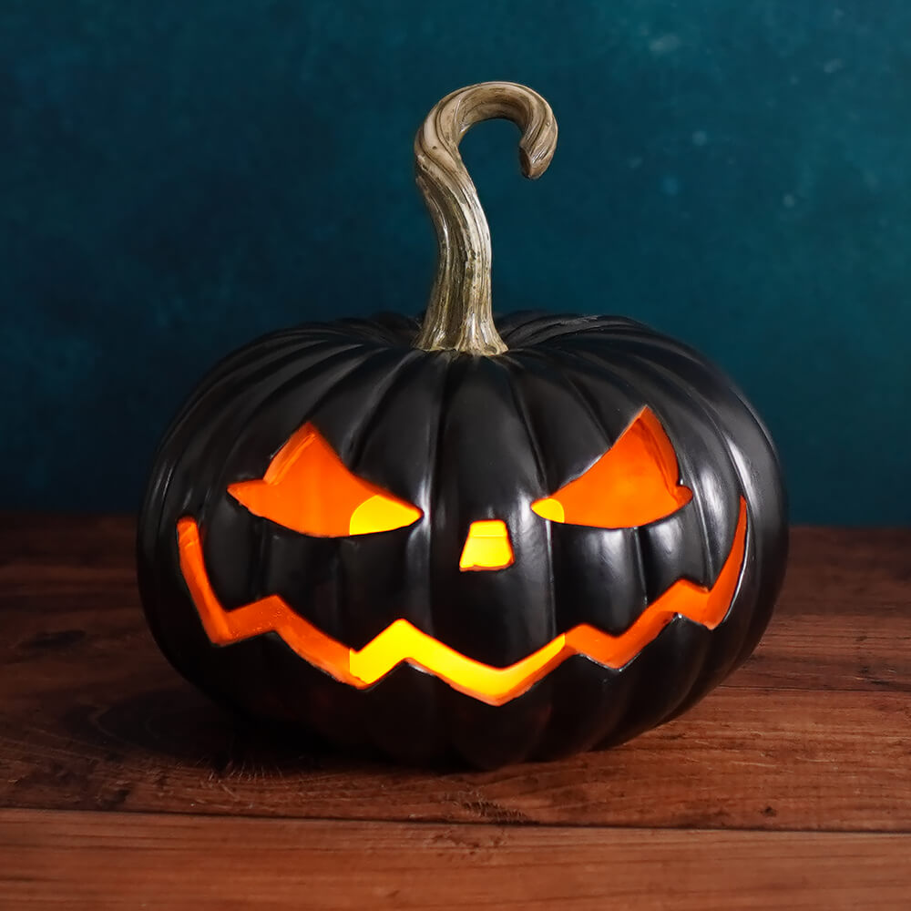 Jack-o’-lantern with a menacing carved face glowing orange from within.