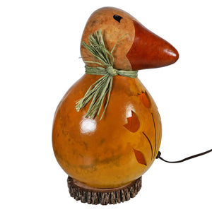 Hand carved large dillard duck gourd lamp in orange with natural wood base and green straw bow with tulip cutout