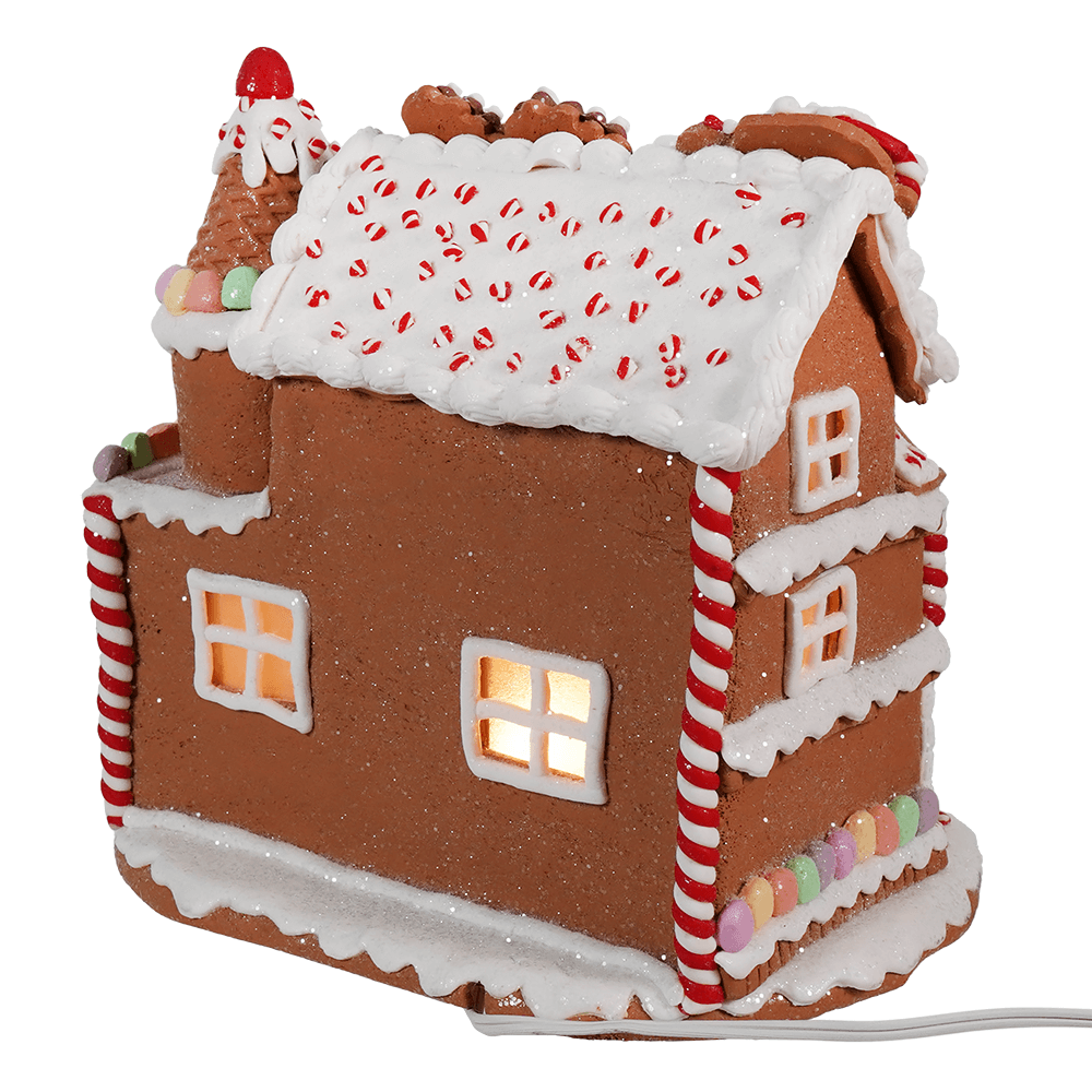 Gingerbread house decorated with candy canes, icing, and illuminated windows.