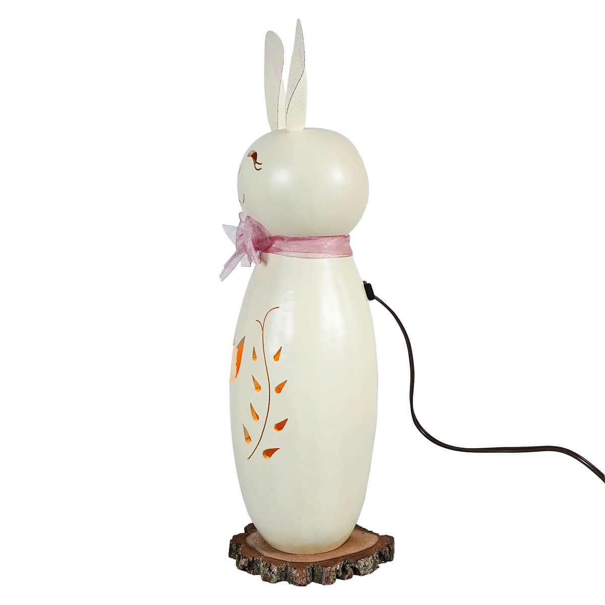 Cream-colored ceramic tall white poppy bunny lamp with pink bow and orange leaf decals on wooden slice base