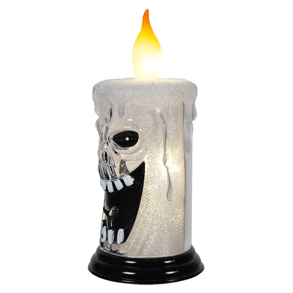 Spooky skull-shaped candle with a glowing flame on top.