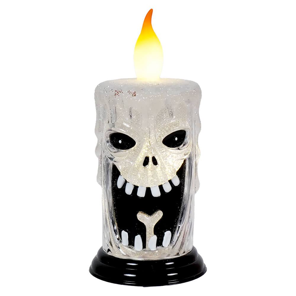 Spooky skull-shaped candle with an electronic flame on top.