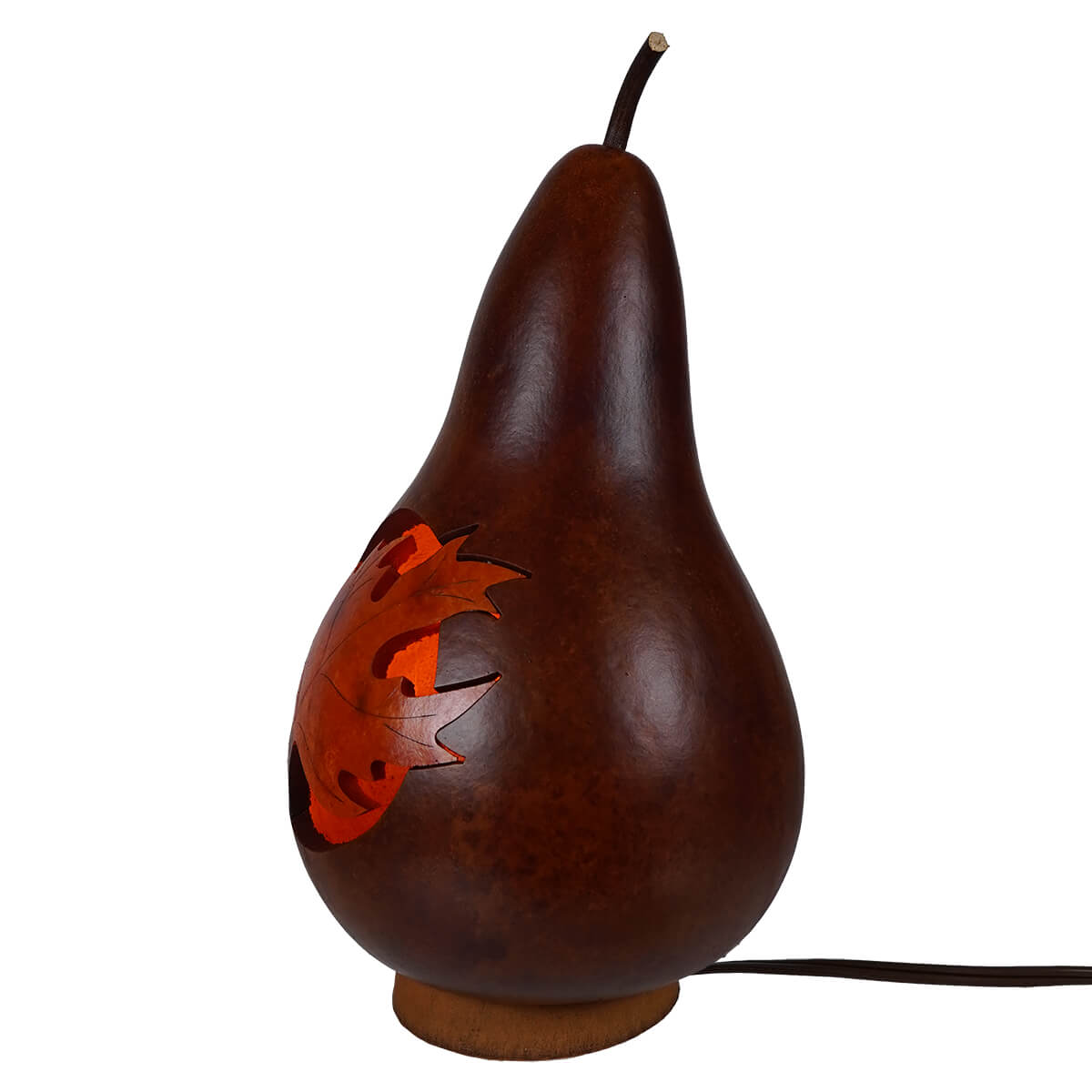 Dark brown hand carved gourd lamp with a glowing lighted maple leaf design unique artisan piece for halloween pumpkins & gourds