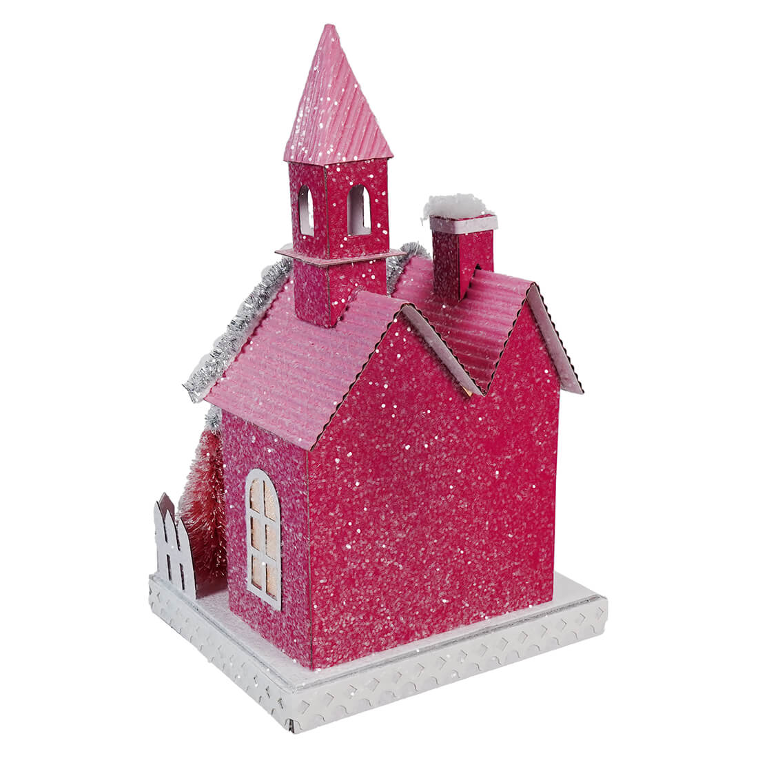 Pink glittery miniature church or house with a steeple and snow-covered roof.