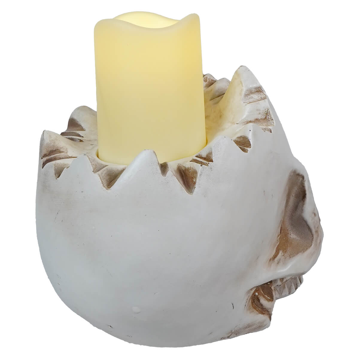 Cream-colored candle sitting in a white ceramic holder with jagged edges.