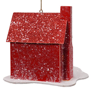 A festive red glittery house ornament with snow-dusted base from a green holiday lane lane house ornaments set
