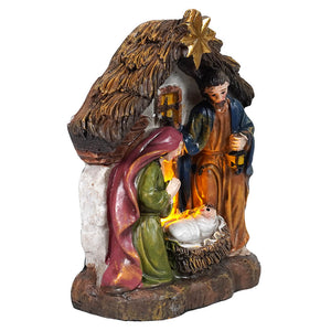 Lighted resin holy family manger scene with mary in green, joseph in orange holding lantern, and baby jesus under golden star