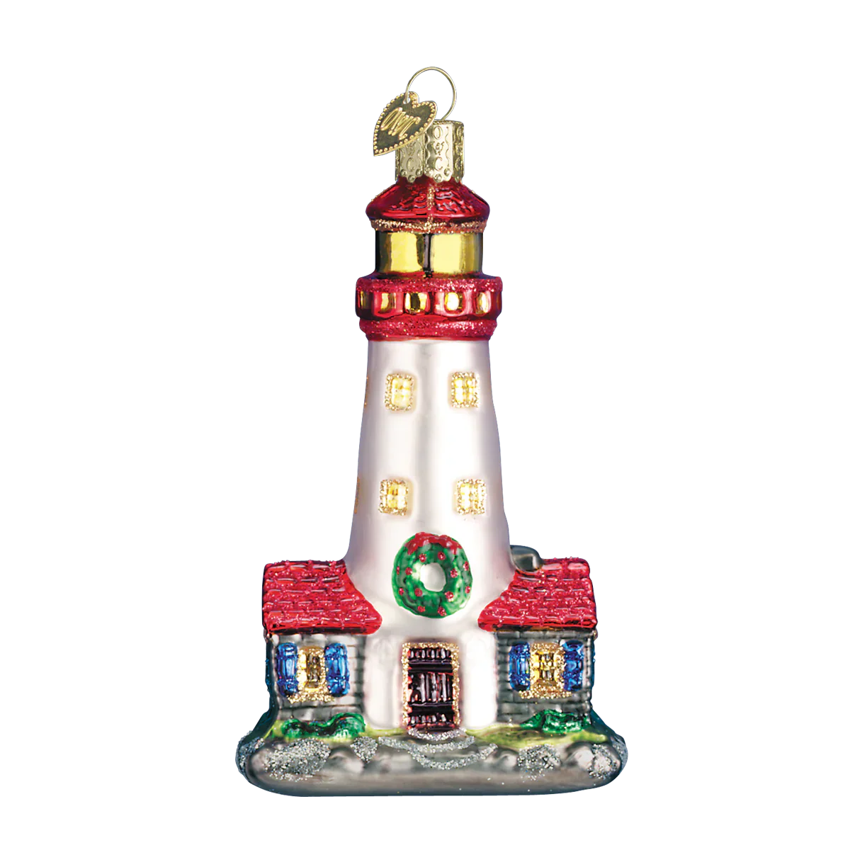 A festive red and white glass lighthouse ornament with gold accents, green wreath, and heart tag figural decor