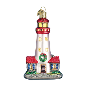 A festive red and white glass lighthouse ornament with gold accents, green wreath, and heart tag figural decor