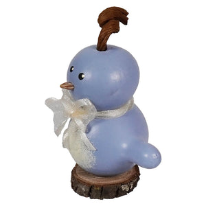 A charming light blue ceramic blue birdie gourd with a brown twig crest and white ribbon for easter and spring tabletop decor