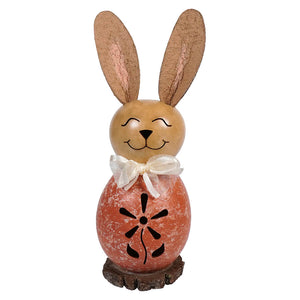 Decorative bunny figurine wearing a white bow and coral-colored outfit with cutout flower pattern.