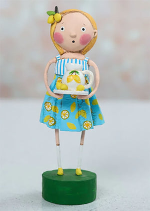 A charming lori mitchell figurine of a girl with lemon-adorned blonde hair wearing lily anne’s lemons outfit