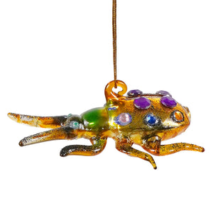 A vibrant hand-blown glass bug ornament featuring sparkling purple blue and green gemstones in lime green tones