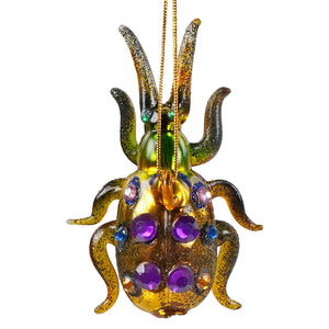 A sparkling lime green horned tiny beetle glass ornament with gold, purple, blue, and clear gemstones bug ornament