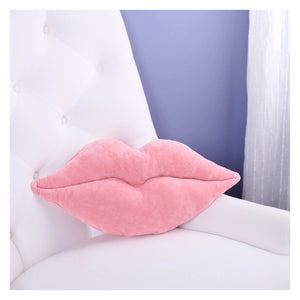 Soft pink plush lips pillow resting on white tufted chair armrest perfect for valentine’s day pillows decor