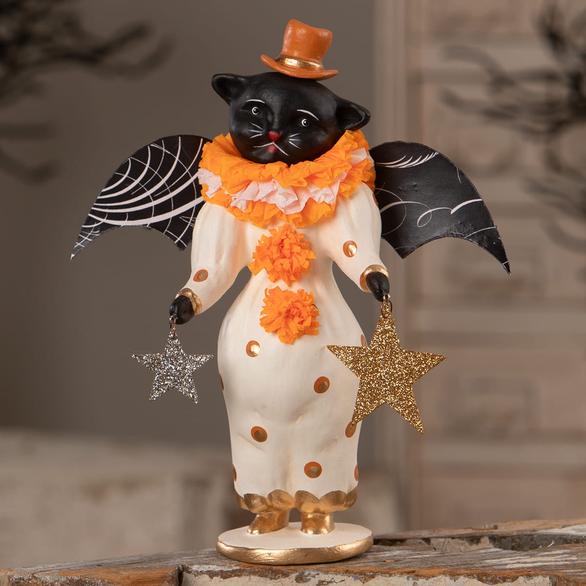 Little fancy pants cat black clown cat figurine in polka dot outfit with top hat holding star ornaments halloween cats