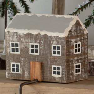 Rustic wooden log cabin stocking holder with weathered brown finish white windows and gray roof with faux snow edges