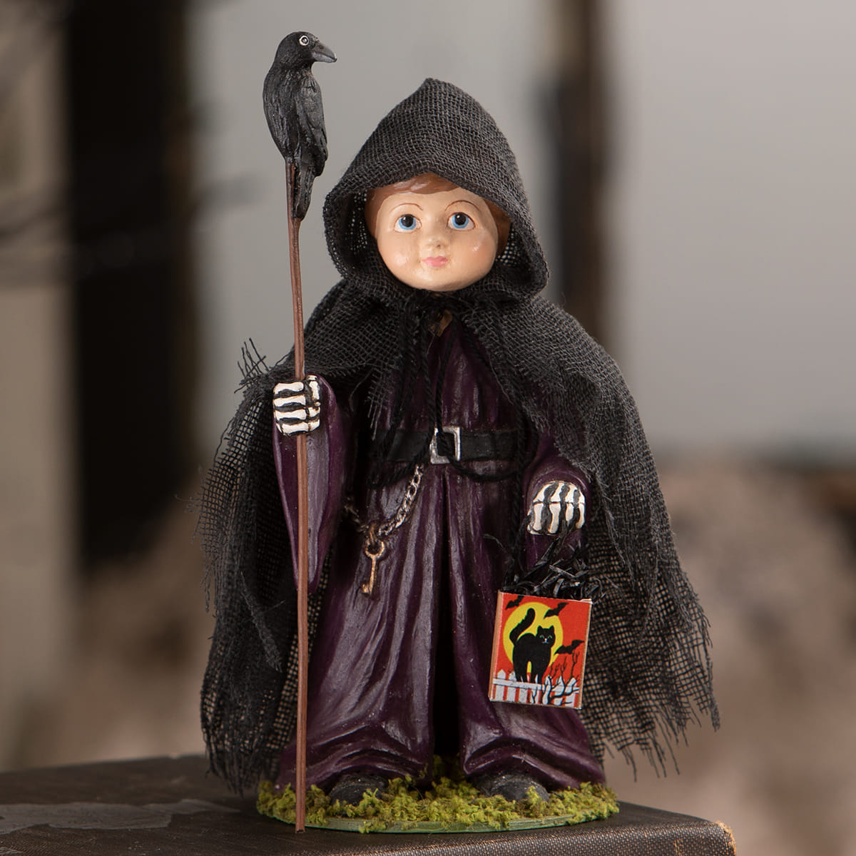 A miniature halloween ghoul with crow figure by bethany lowe featuring a child in purple robe holding a staff and crow