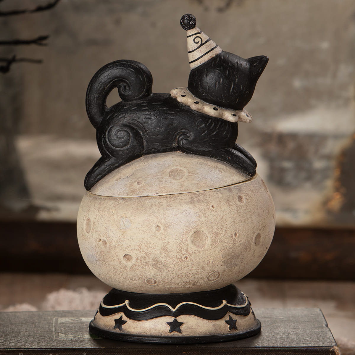 Black ceramic cat figurine wearing striped party hat on textured moon lid from loony jack o luna jack o lantern set