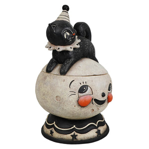 Black cat figurine with striped party hat and lace collar atop cream jack o lantern moon cookie jar smiling face